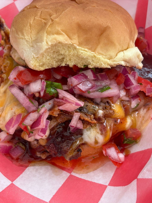 Loaded grilled cheese topped with pico de gallo and pickled onion